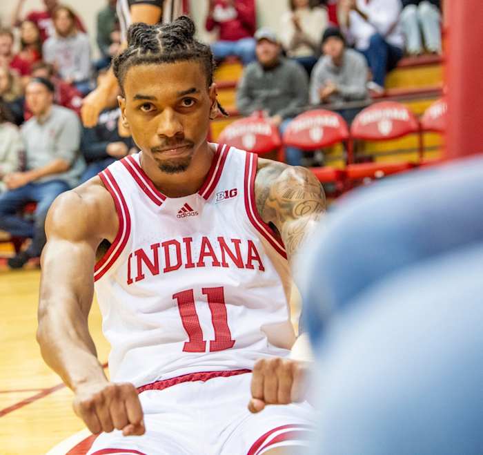 Indiana's CJ Gunn (11) flexes after scoring and getting fouled during the Indiana versus University of Indianapolis men's basketball game.